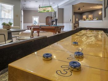 A pool table in a room with a billiard ball on it.